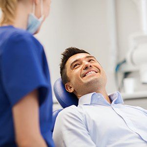 man smiling up at dental hygienist