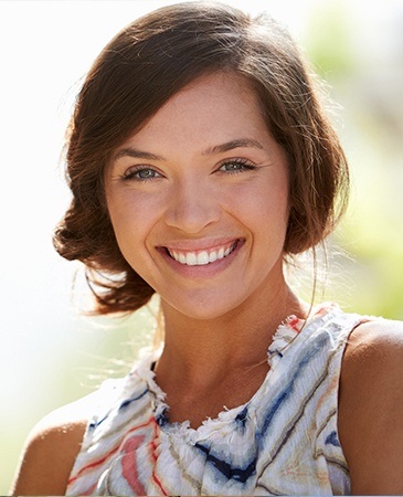 woman with hair in bun smiling