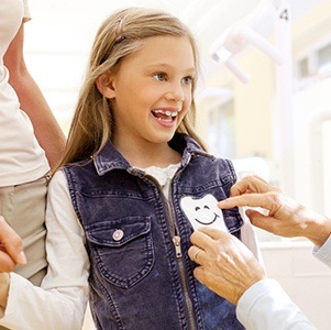 girl getting tooth sticker