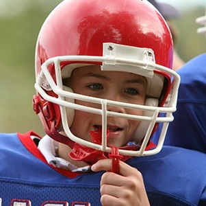 boy putting in mouthguard