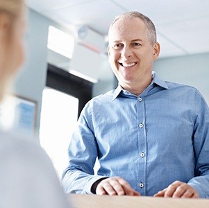 man smiling at front desk