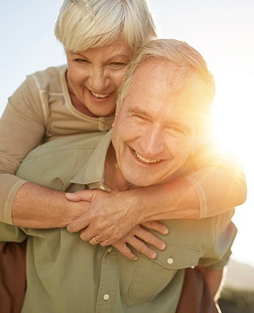 man giving wife piggyback ride