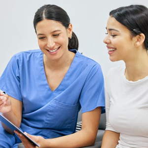 Dental team member assisting patient with paperwork