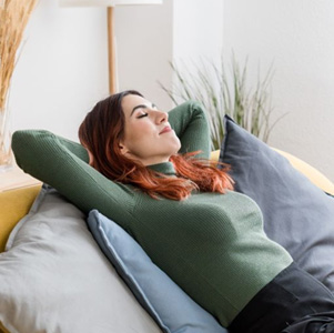 Woman resting peacefully on her sofa