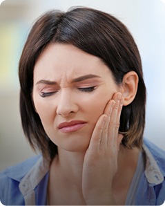 Woman holding her cheek in pain