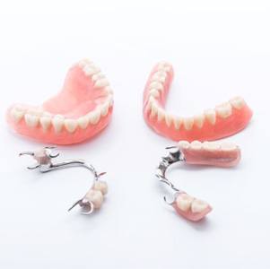 Full and partial dentures against white background