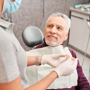 Senior patient receiving new dentures