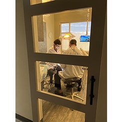 dental team in exam room working on patient