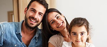 family of three smiling