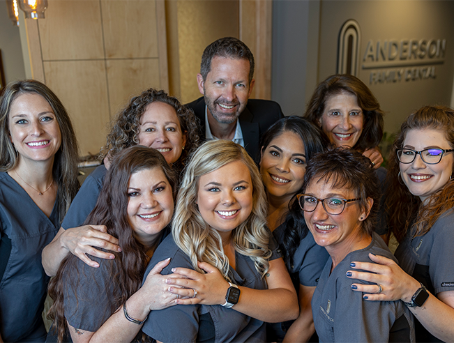 Colorado Springs dentist and dental team members smiling