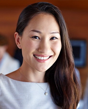 woman in grey dress smiling