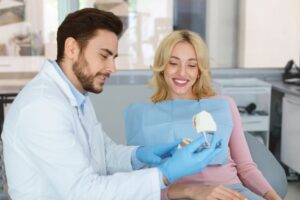 Dentist and patient conversing during dental implant consultation