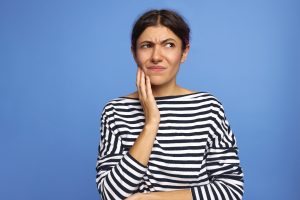 Frowning woman thinking about rare oral health problems