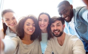 Group of friends enjoying the benefits of smiling