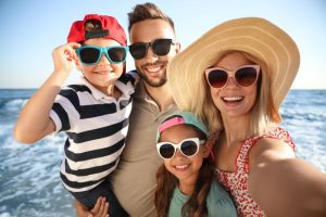 Happy family taking selfie during summer vacation