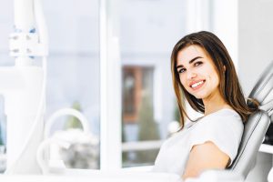 Happy female patient attending dental checkup and cleaning