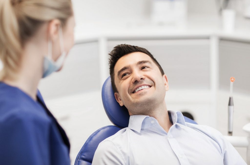 Man smiling at dentist during dental checkup