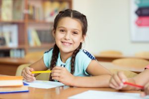 Smiling girl at school after visiting children’s dentist