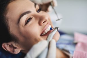 Smiling patient at appointment for dental cleaning and checkup