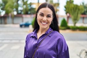 Smiling woman with beautiful teeth wearing purple blouse