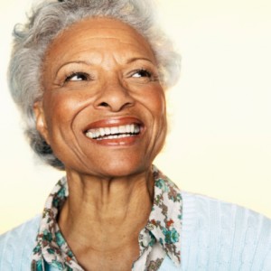 senior woman with a beautiful complete smile thanks to the implant retained dentures colorado springs residents rely on