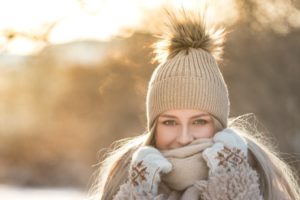 Woman enjoying winter after applying advice to combat winter mouth issues