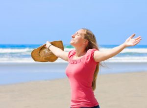 Woman on beach, soaking up the sun