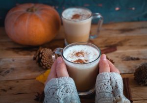 holding pumpkin spice latte