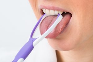 using a tongue scraper