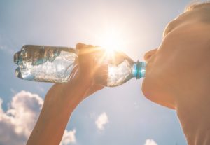  woman following dentist’s recommendation to drink plenty of water